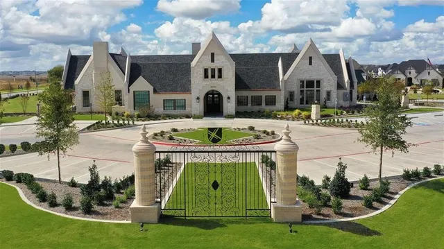 an aerial view of a house with outdoor seating