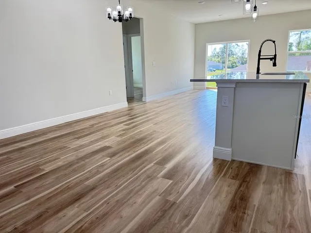 a view of a room with wooden floor and a window
