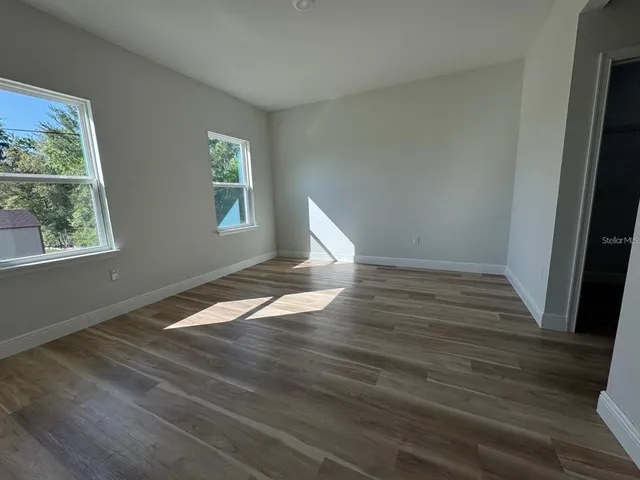 wooden floor in an empty room with a window