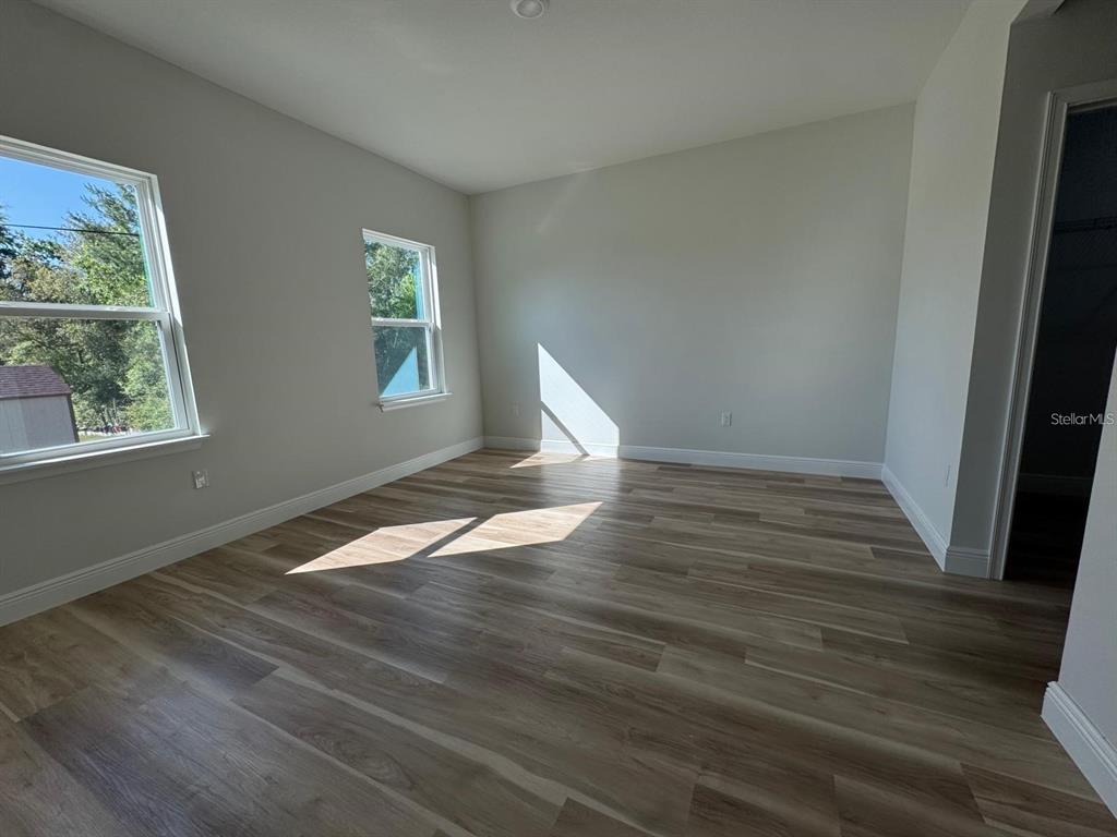 2336 Southwest 168th Loop Ocala, FL 34473 - Photo 20 of 40 wooden floor in an empty room with a window