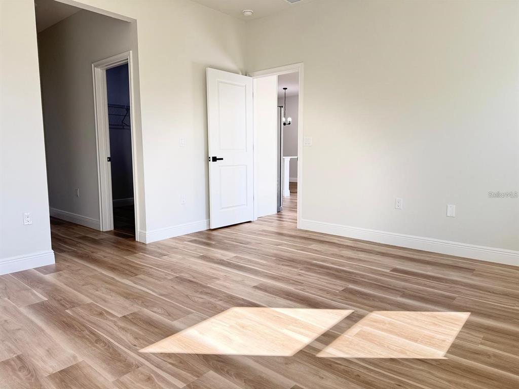 2336 Southwest 168th Loop Ocala, FL 34473 - Photo 22 of 40 a view of a room with wooden floor and white walls