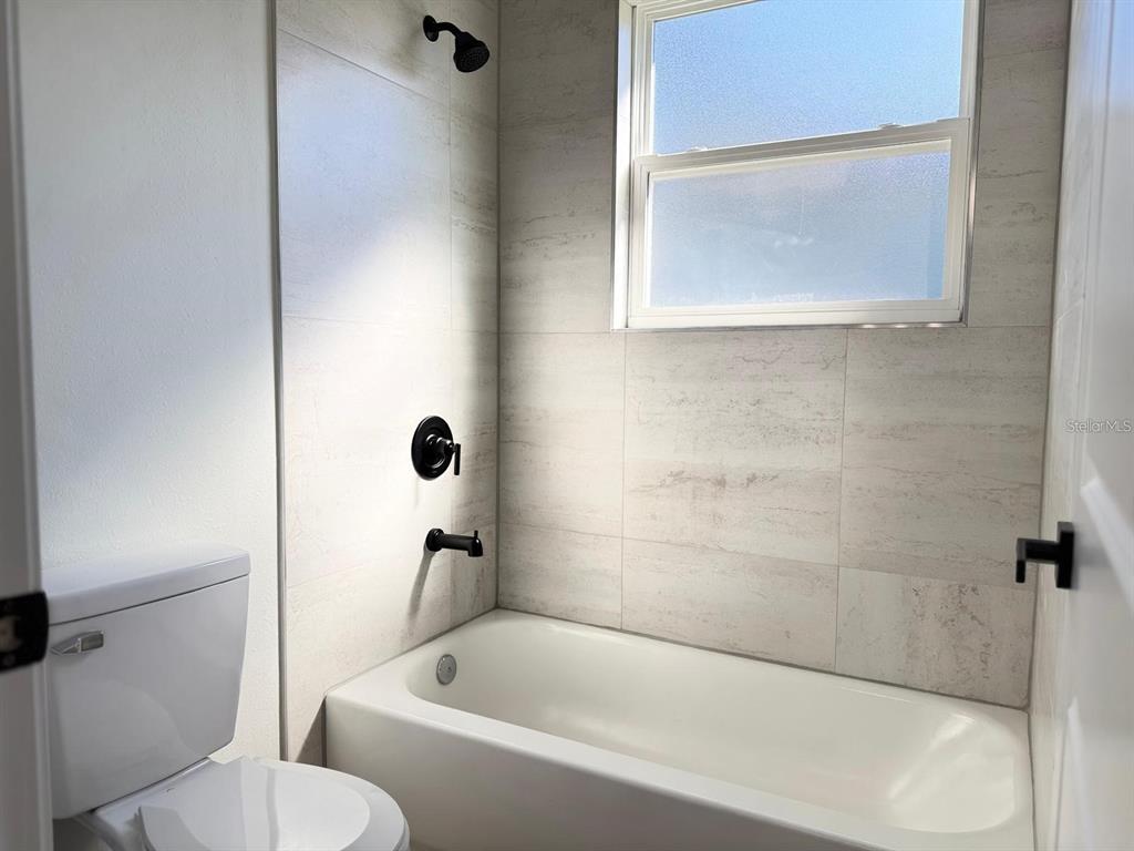 2336 Southwest 168th Loop Ocala, FL 34473 - Photo 28 of 40 a bathroom with a toilet and a bathtub