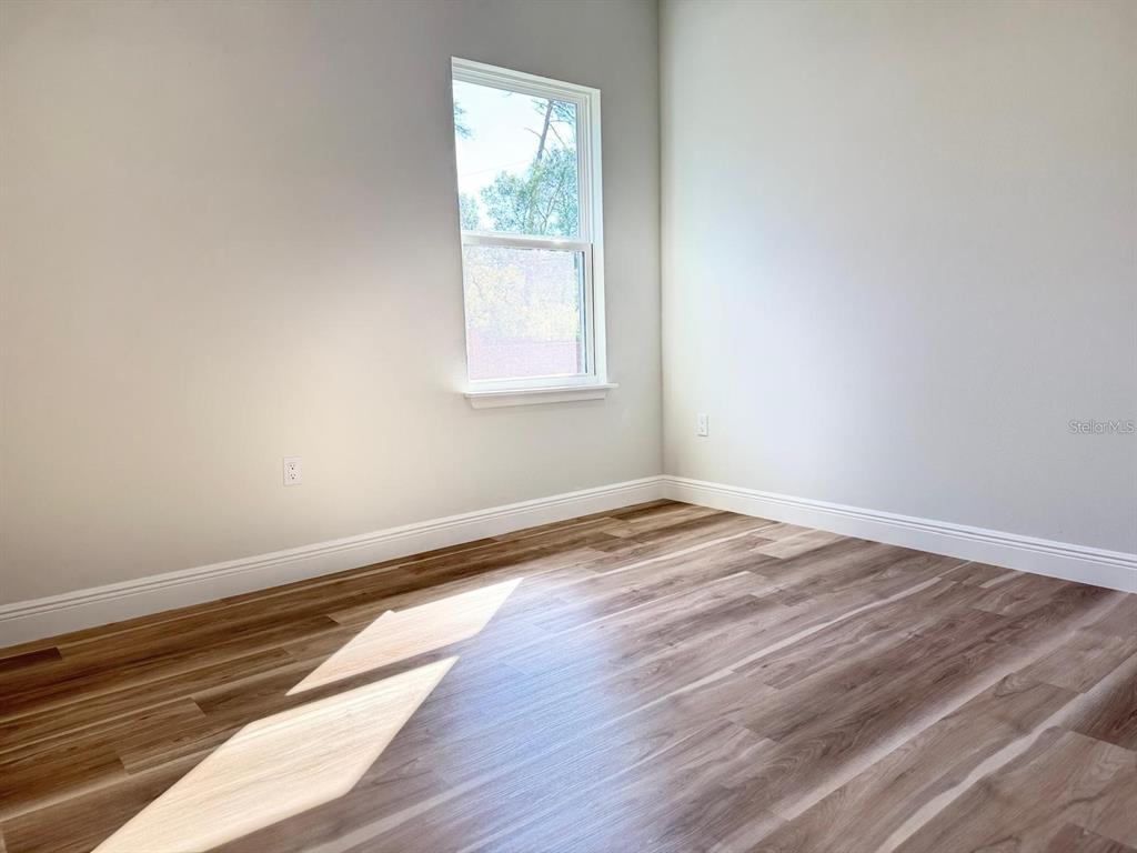 2336 Southwest 168th Loop Ocala, FL 34473 - Photo 37 of 40 an empty room with wooden floor and windows