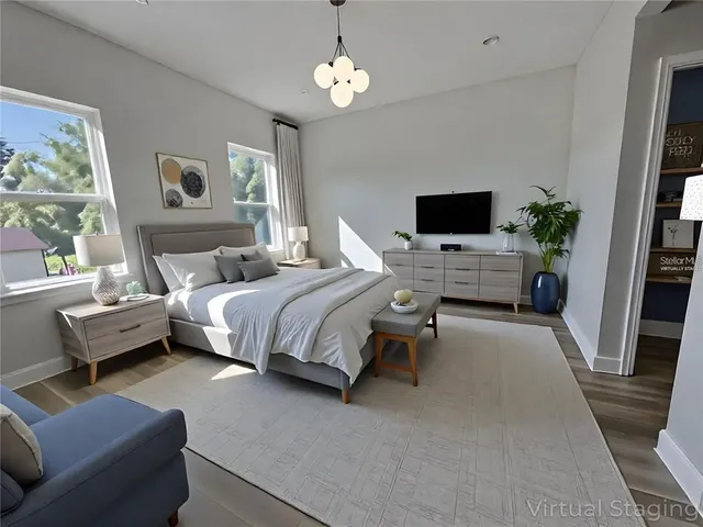 a bedroom with furniture and a flat screen tv