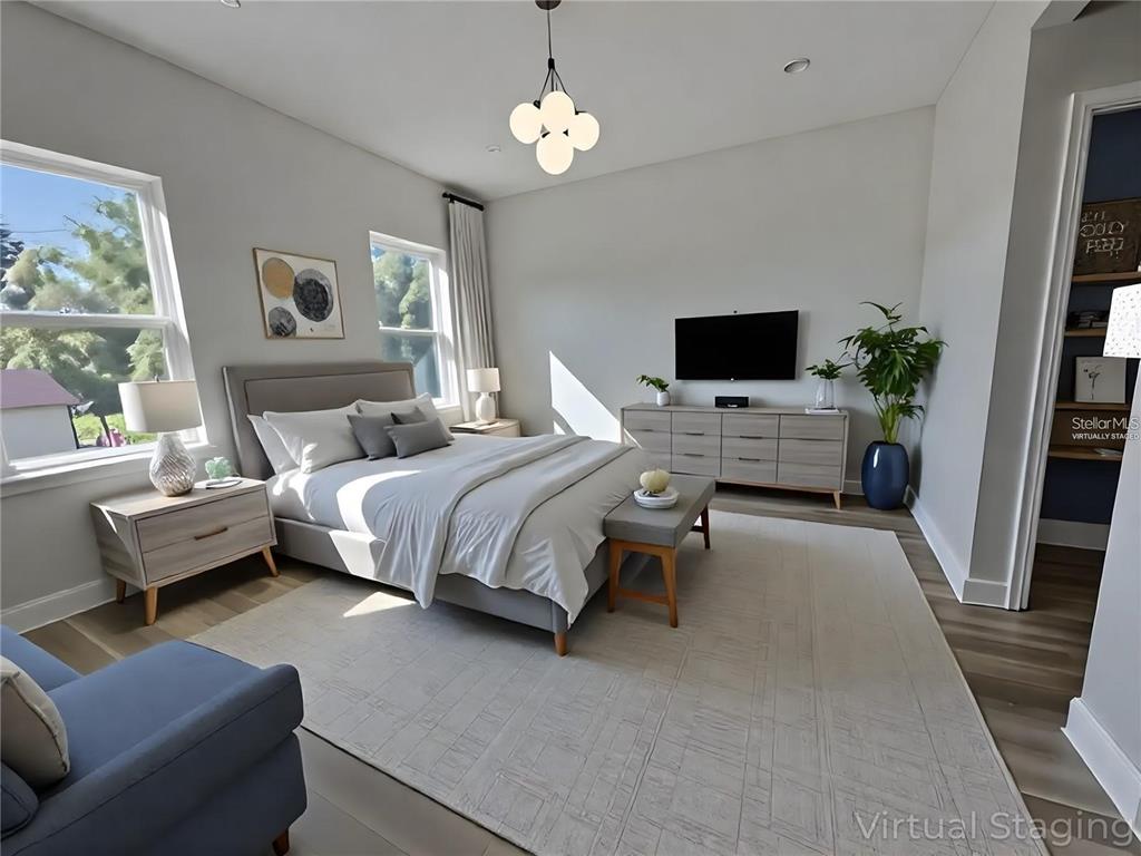 2336 Southwest 168th Loop Ocala, FL 34473 - Photo 4 of 40 a bedroom with furniture and a flat screen tv