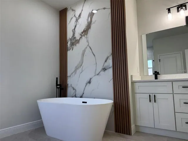 a bathroom with a bathtub and a sink