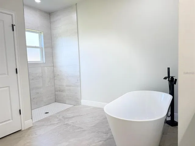 a white bath tub sitting in a bathroom