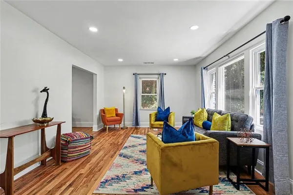 a kitchen with stainless steel appliances granite countertop a refrigerator a stove top oven a sink dishwasher and a refrigerator with wooden floor