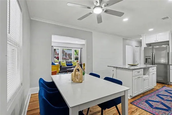 a kitchen with stainless steel appliances granite countertop a stove a sink and a refrigerator