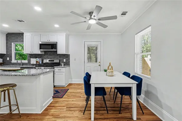 a kitchen with stainless steel appliances granite countertop a stove and a sink