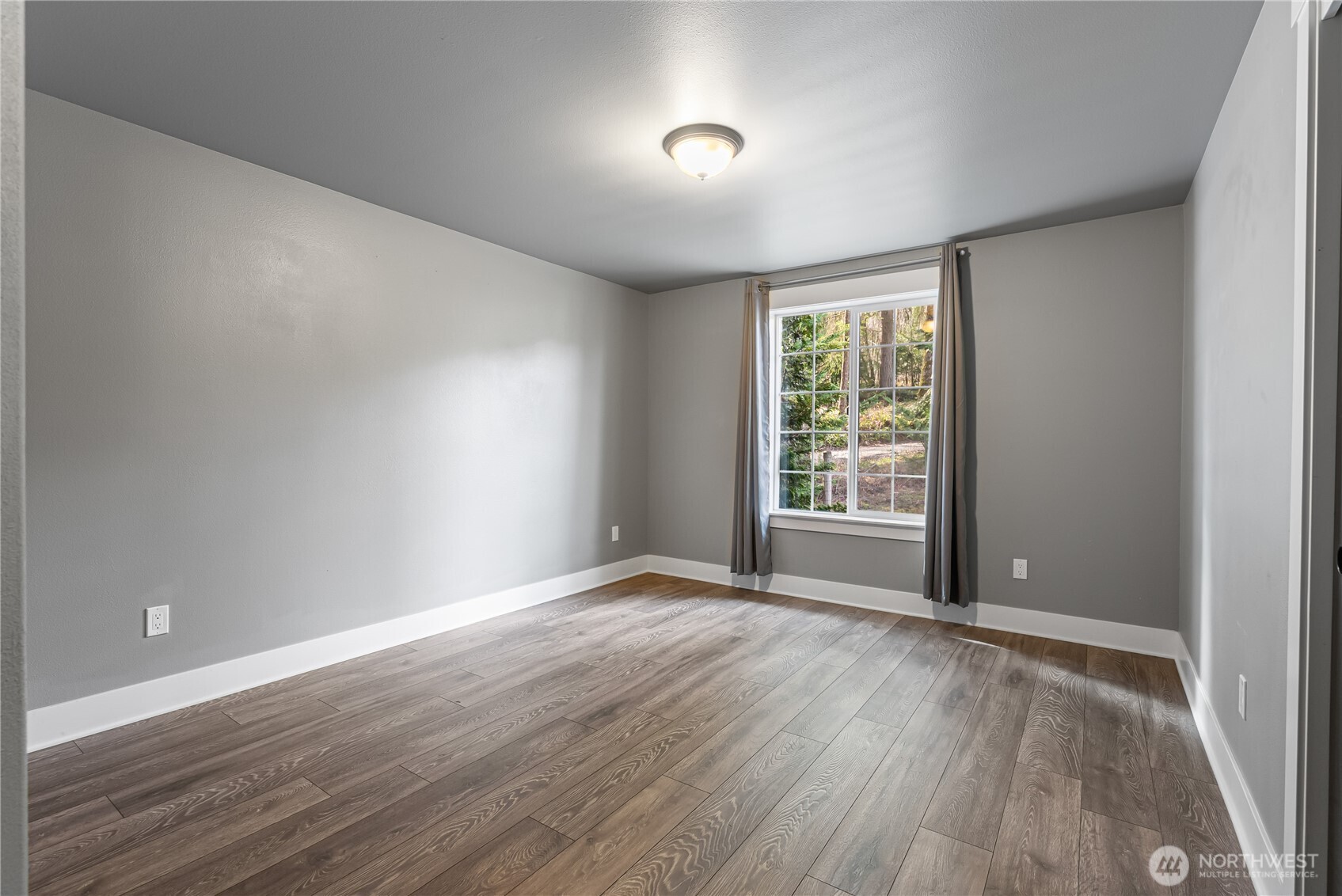 159 Salzer Road Centralia, WA 98531 - Photo 14 of 40 a view of an empty room with wooden floor and a window