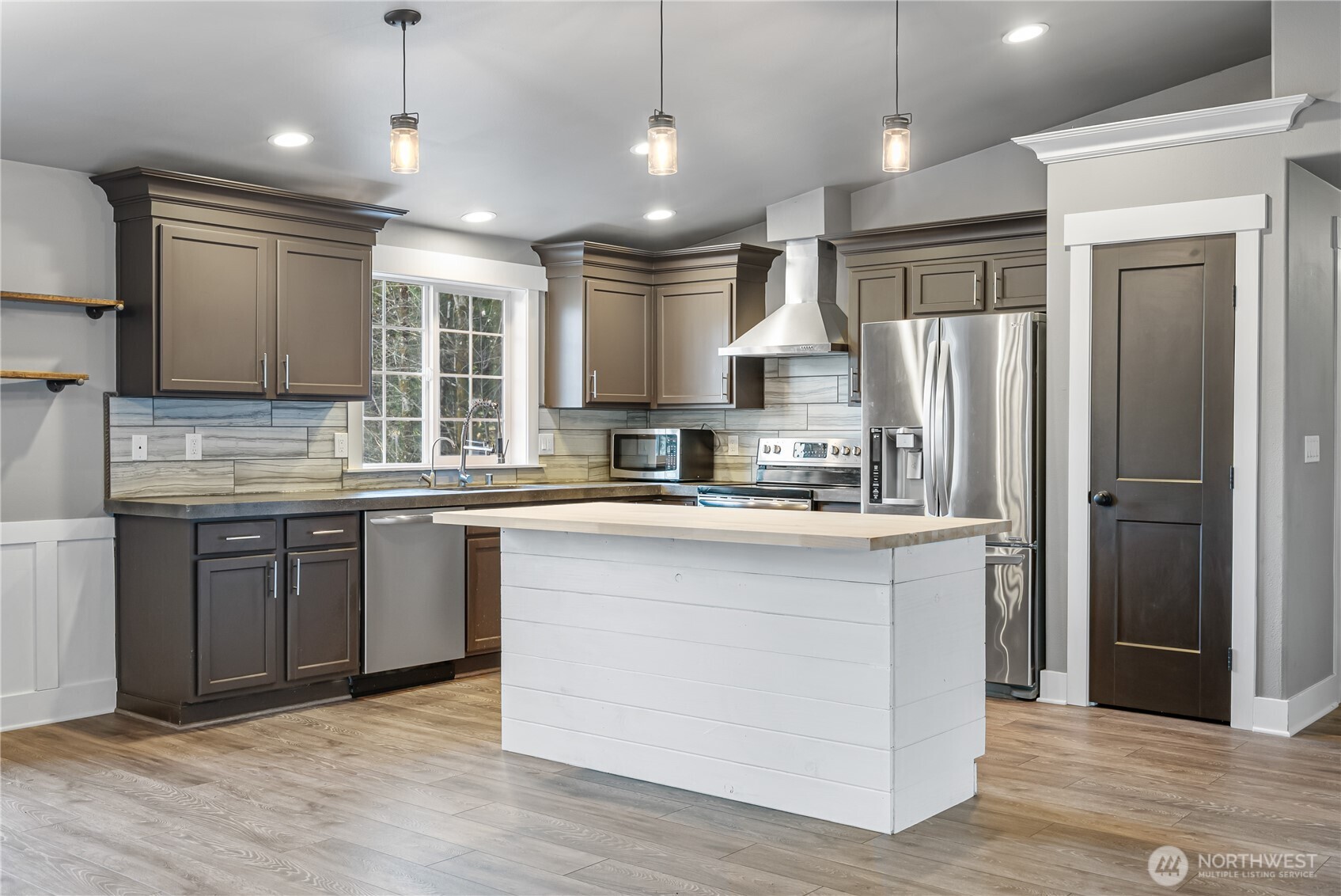159 Salzer Road Centralia, WA 98531 - Photo 6 of 40 a kitchen with stainless steel appliances granite countertop a refrigerator a sink dishwasher a stove and white cabinets with wooden floor
