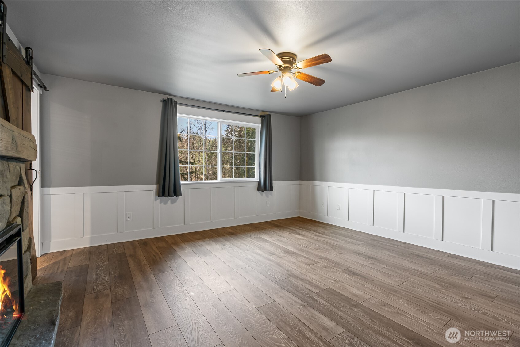 159 Salzer Road Centralia, WA 98531 - Photo 10 of 40 an empty room with wooden floor fan and windows