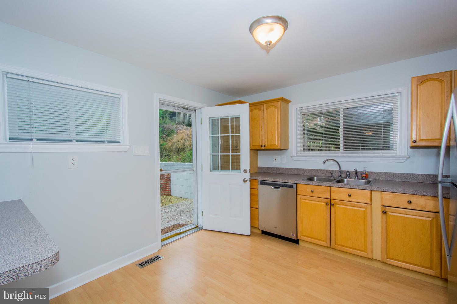 7732 West A W Shore Road Pasadena, MD 21122 - Photo 11 of 43 Exit door from kitchen to deck and paver patio