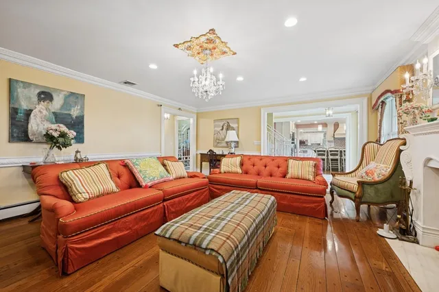 a living room with furniture and a chandelier