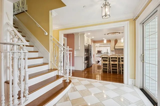 a view of a bedroom with wooden floor and stairs