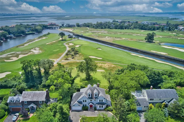 an aerial view of a house with a yard swimming pool and outdoor seating