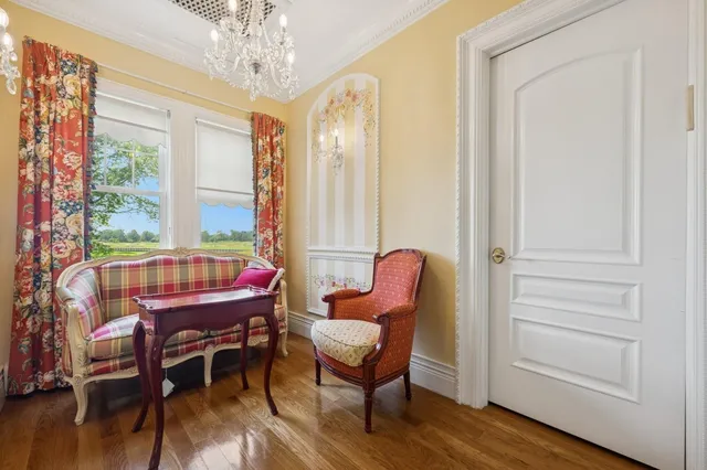 a dining room with furniture window and wooden floor