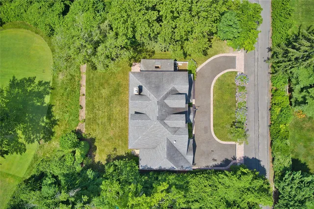 an aerial view of a house with a swimming pool and garden