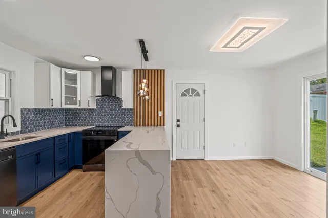 a kitchen with a sink stove and cabinets