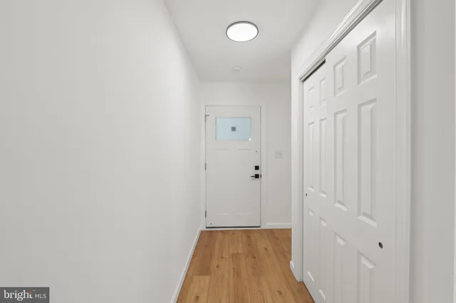 a view of a hallway with wooden floor
