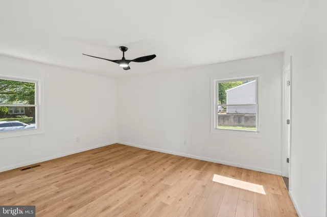 a view of a room with a ceiling fan and a window