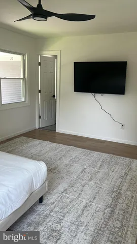 a living room with furniture a window and a lamp