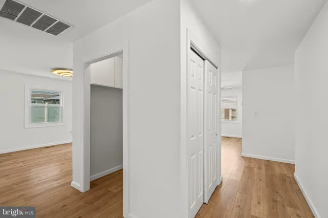 a view of a hallway with wooden floor