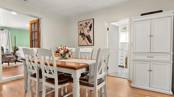 a view of a dining room with furniture wooden floor and front door
