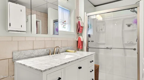 a bathroom with a sink double vanity and shower