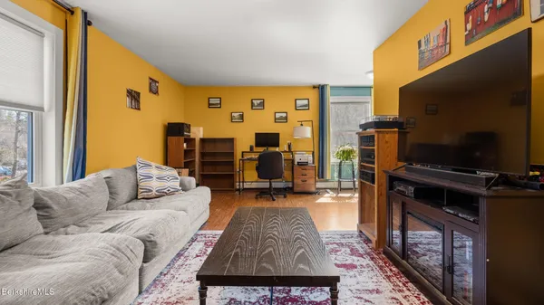 a view of a workspace with furniture and a window