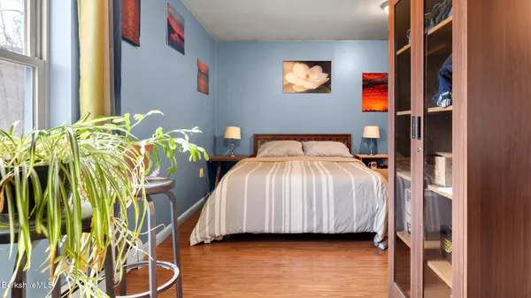 a bedroom with a bed and a lamp