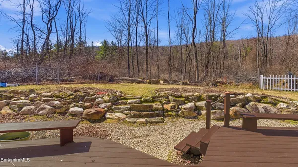 a view of a patio with wooden fence
