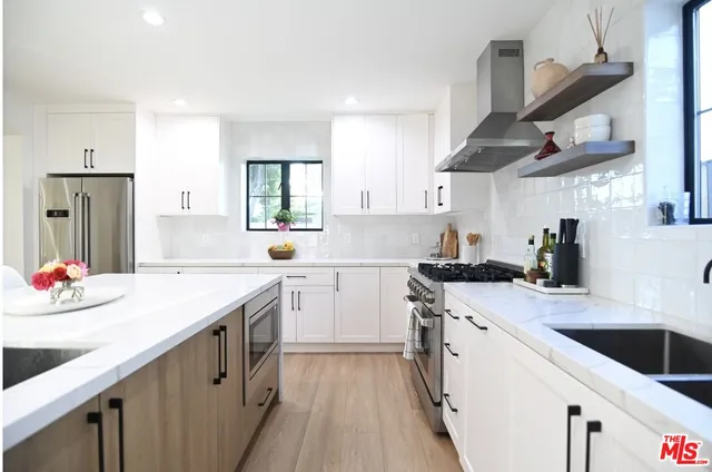 a kitchen with stainless steel appliances a sink stove and refrigerator