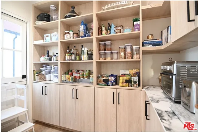 a kitchen with white cabinets and white appliances