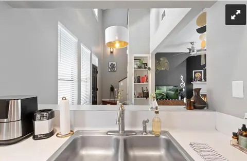 a kitchen with a sink and a stove top oven