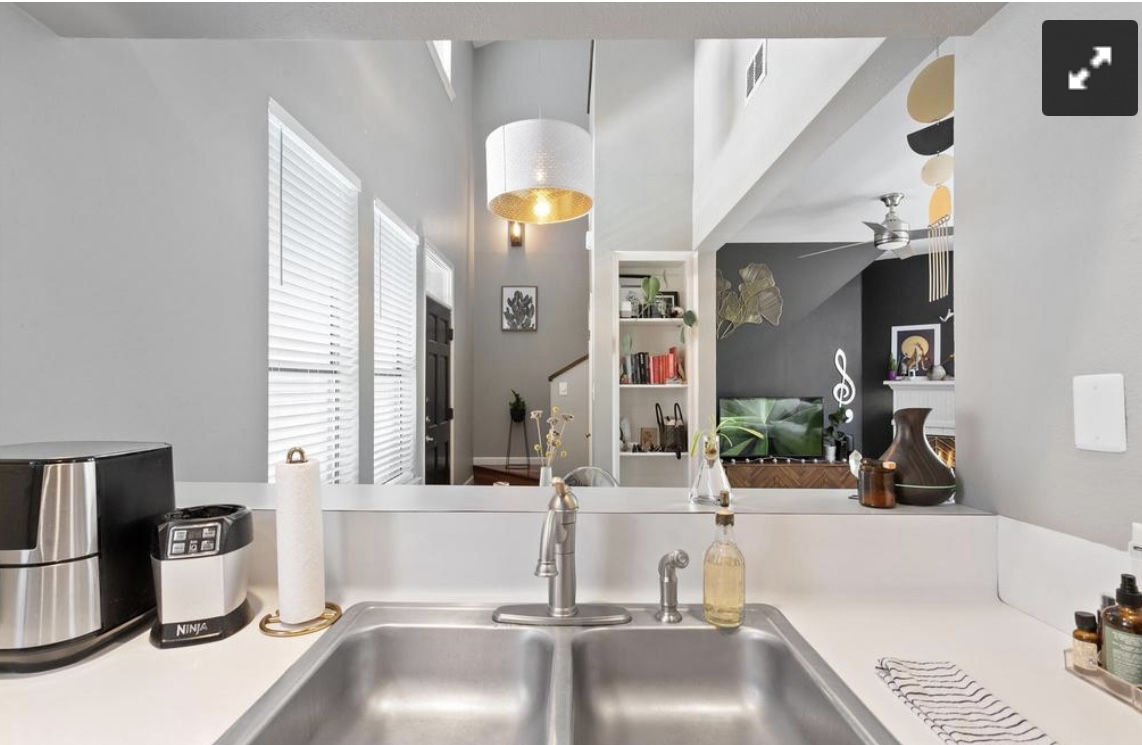 611 East 45th Street, Unit 25 Austin, TX 78751 - Photo 11 of 17 Kitchen view of built in shelves, light countertops, a ceiling fan, and hanging light fixtures