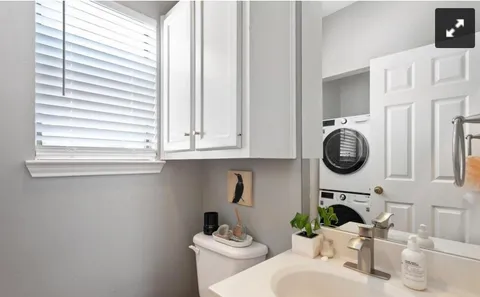 a bathroom with a sink a toilet and a window