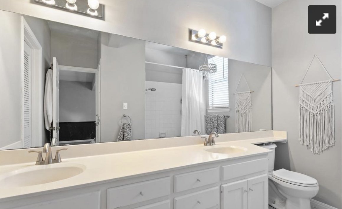 611 East 45th Street, Unit 25 Austin, TX 78751 - Photo 17 of 17 Bathroom with double vanity and a shower with curtain