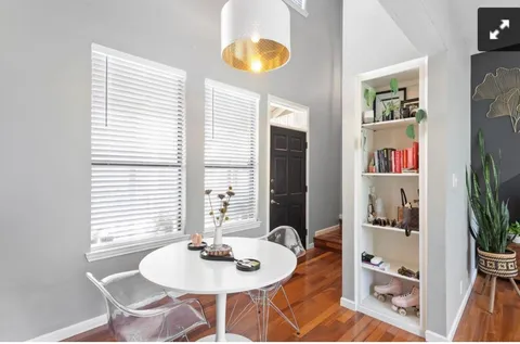 a dining room with furniture and wooden floor