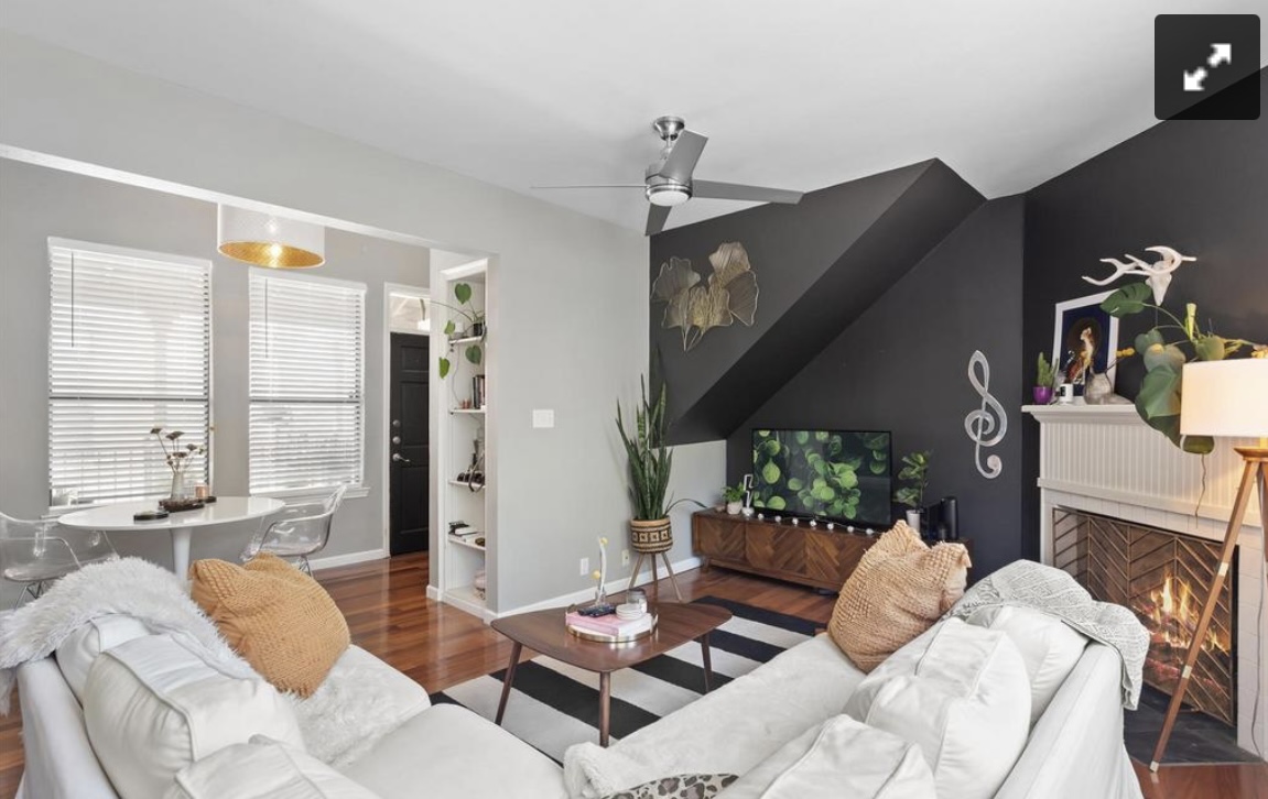 611 East 45th Street, Unit 25 Austin, TX 78751 - Photo 7 of 17 Living area with wood finished floors, a ceiling fan, and a lit fireplace