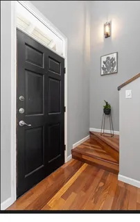 a view of bedroom with wooden floor