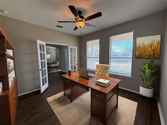 a work room with furniture and wooden floor