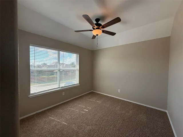 a view of a livingroom with a ceiling fan and window