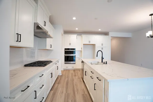 a bathroom with a toilet a sink a light fixture and a mirror