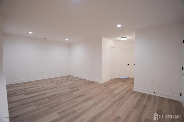 a view of room with wooden floor