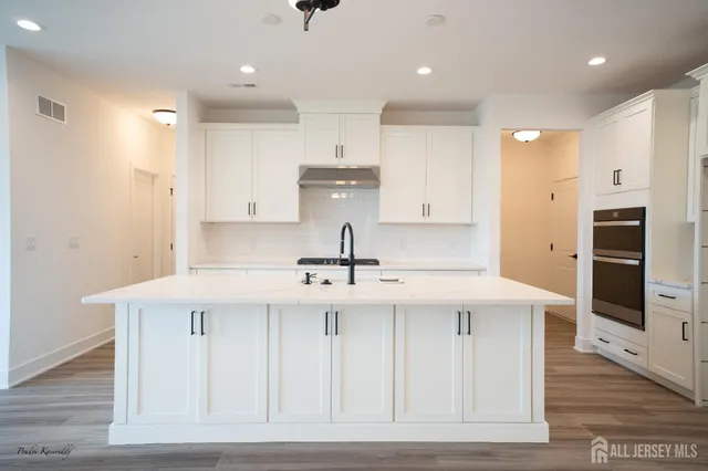 a kitchen with a sink stainless steel appliances and cabinets