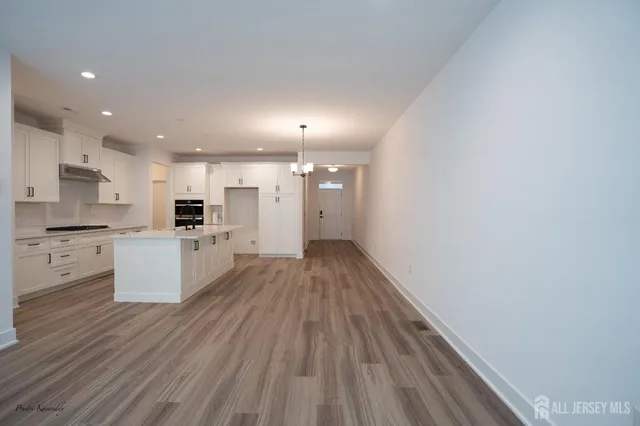 a view of a kitchen with white cabinets