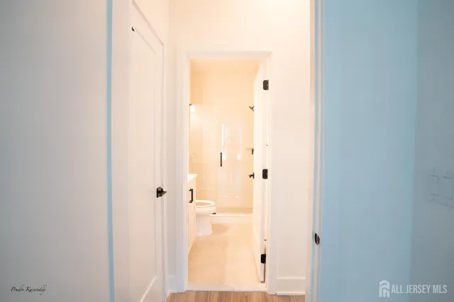 a view of a hallway with wooden floor