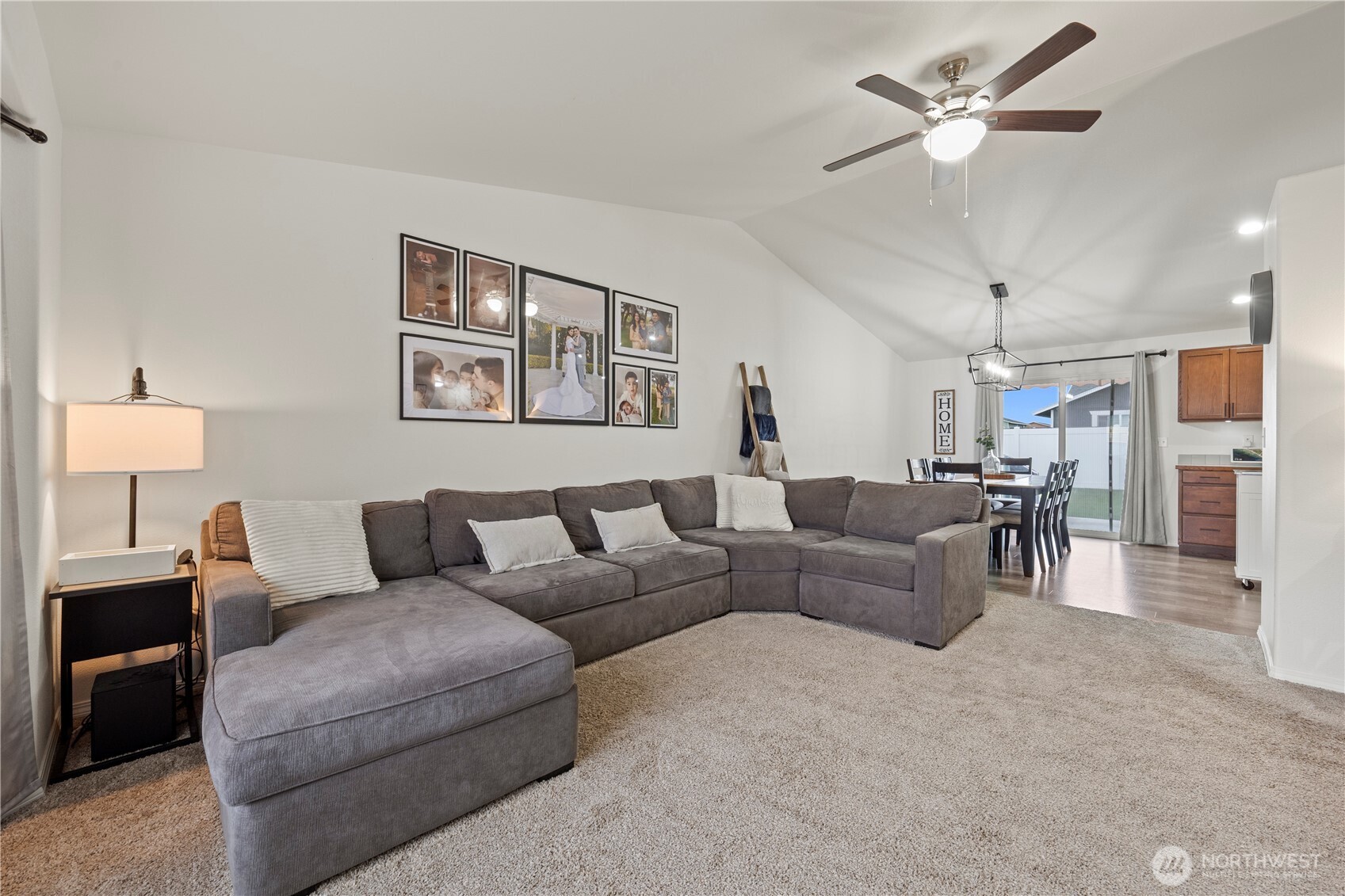 1045 Sandstone Street Othello, WA 99344 - Photo 12 of 20 a living room with furniture a chandelier and a ceiling fan